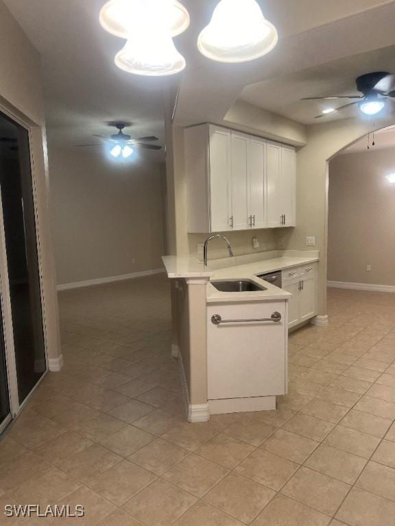 kitchen with white cabinetry, sink, light tile patterned flooring, and ceiling fan