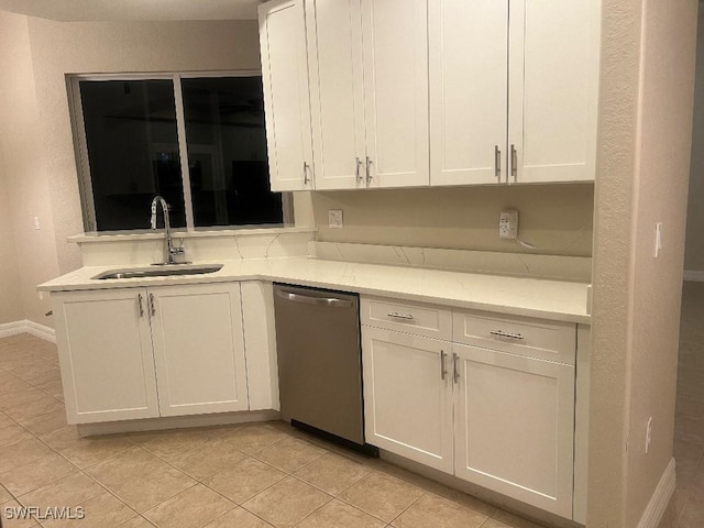 kitchen with stainless steel dishwasher, sink, and white cabinets