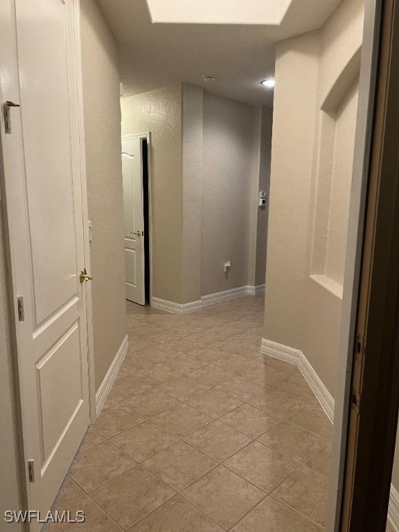 hallway featuring light tile patterned floors