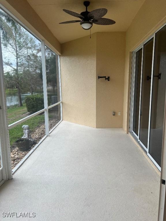 unfurnished sunroom with ceiling fan