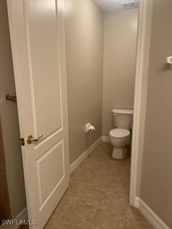 bathroom featuring tile patterned flooring and toilet