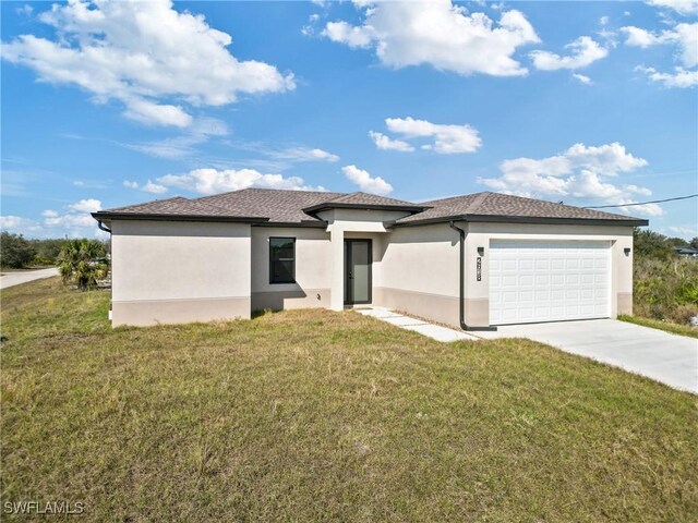 view of front of property with a garage and a front lawn