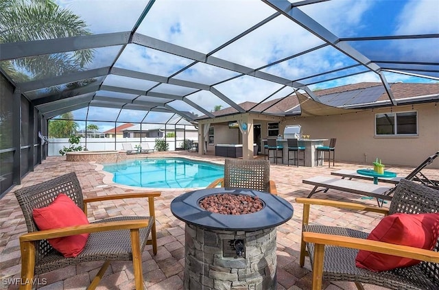 view of pool featuring a bar, a patio, a lanai, and a fire pit