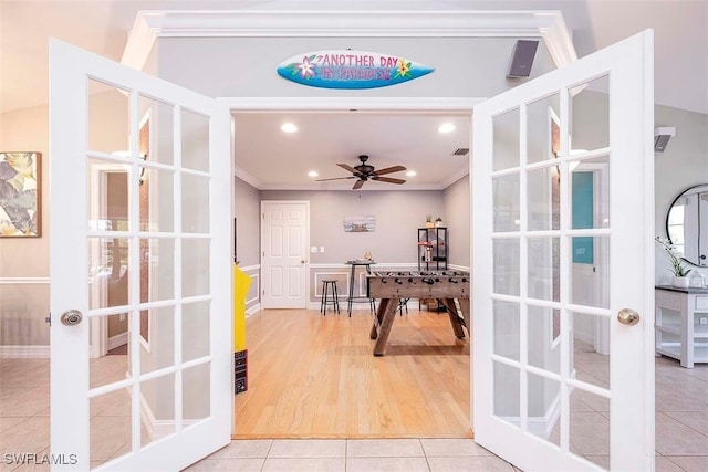 interior space featuring french doors, ceiling fan, tile patterned floors, and crown molding