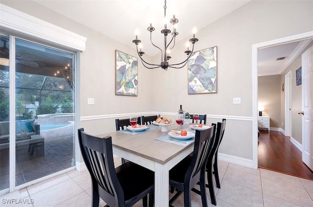 tiled dining room with an inviting chandelier