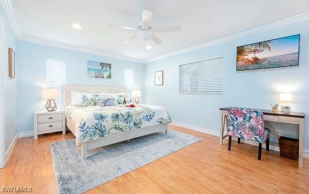 bedroom with ornamental molding, light hardwood / wood-style floors, and ceiling fan