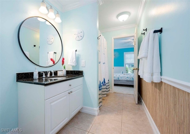 bathroom with crown molding, tile patterned floors, wooden walls, and vanity