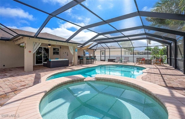 view of swimming pool featuring an outdoor living space, a lanai, a patio area, and ceiling fan