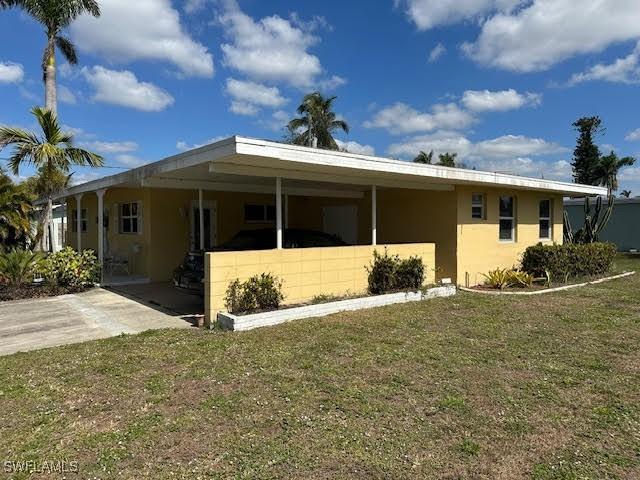 exterior space featuring a carport and a yard