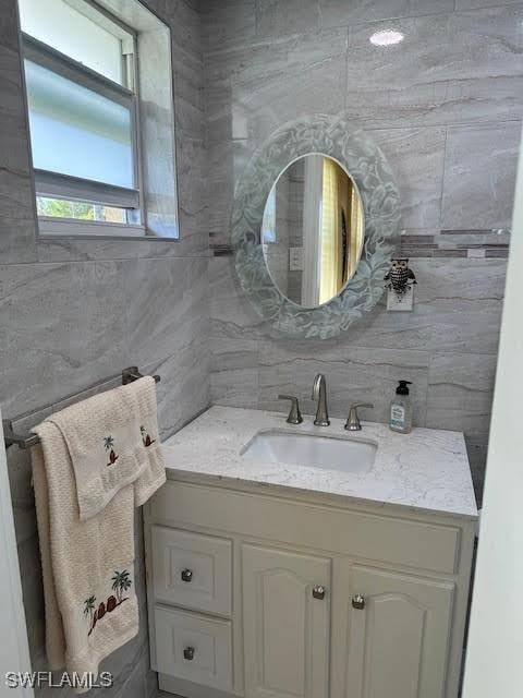 bathroom with vanity and decorative backsplash