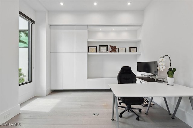 office featuring a wealth of natural light and light hardwood / wood-style floors