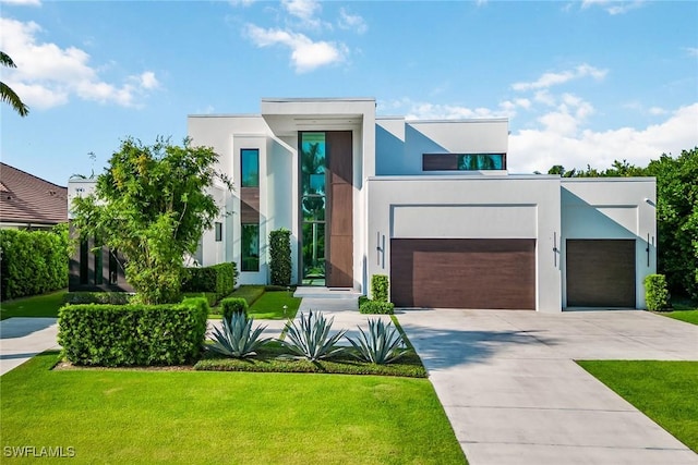 modern home featuring a garage and a front yard