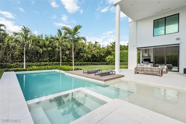 view of pool with an outdoor living space, an in ground hot tub, a lawn, and a patio