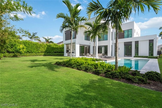 rear view of property featuring a yard