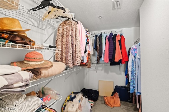 walk in closet featuring carpet flooring