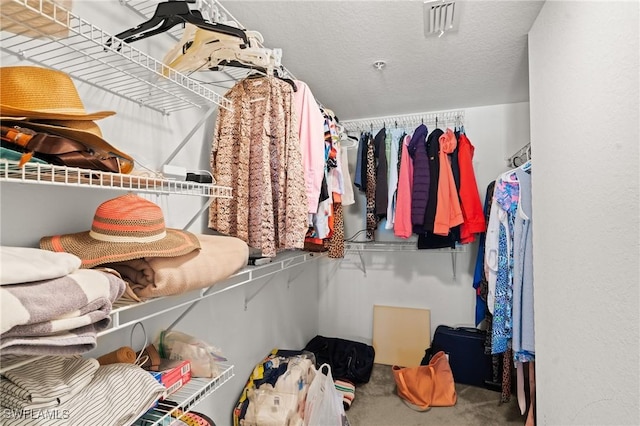 walk in closet with carpet