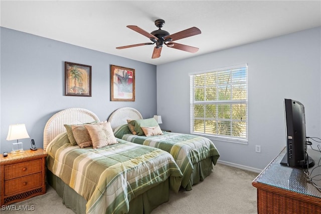 bedroom with light carpet, baseboards, and ceiling fan