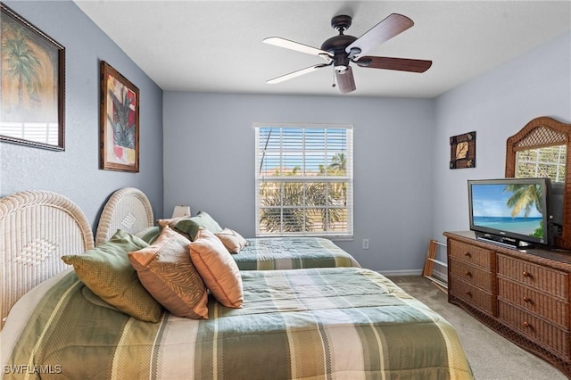 bedroom featuring baseboards, a ceiling fan, and light carpet