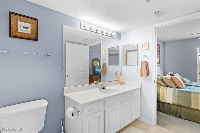 ensuite bathroom with vanity, toilet, baseboards, ensuite bath, and visible vents