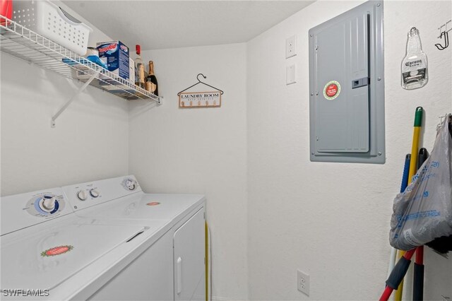 laundry area featuring washing machine and clothes dryer, laundry area, and electric panel