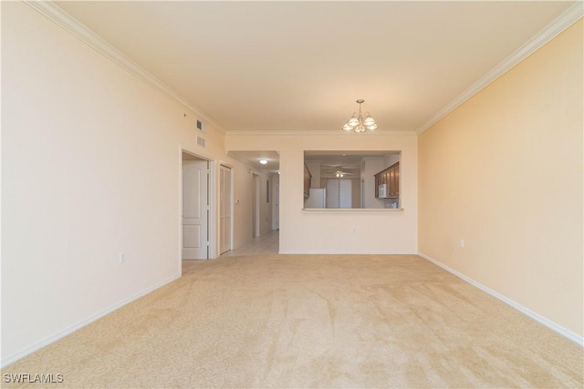 unfurnished room featuring light carpet, a notable chandelier, and crown molding