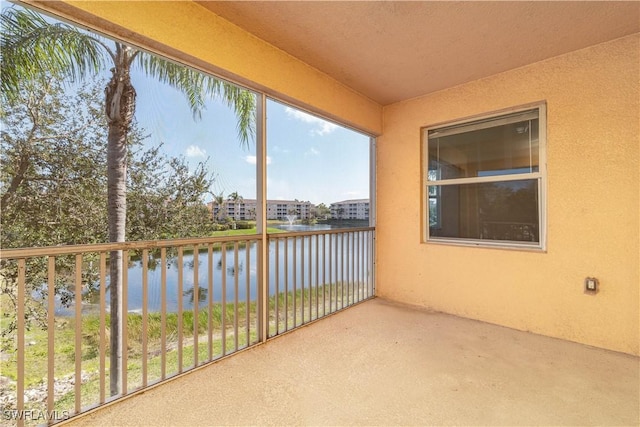 unfurnished sunroom featuring a water view