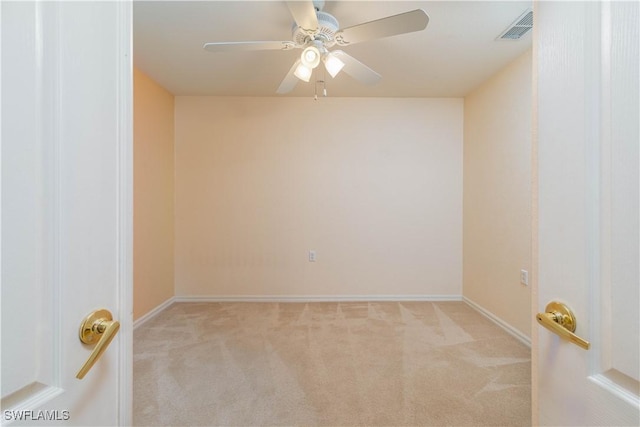 unfurnished room featuring light colored carpet and ceiling fan