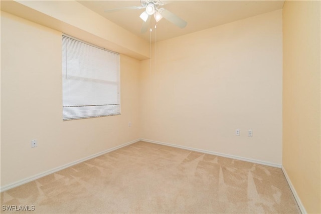 empty room featuring ceiling fan and light colored carpet