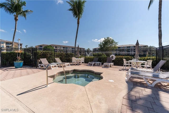 view of pool featuring a hot tub and a patio area