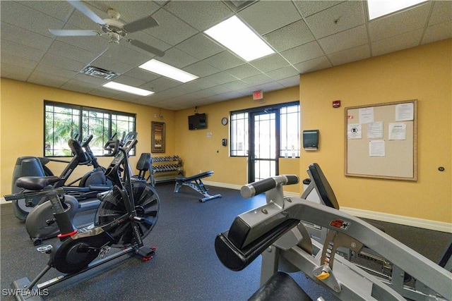 workout area with a drop ceiling and ceiling fan