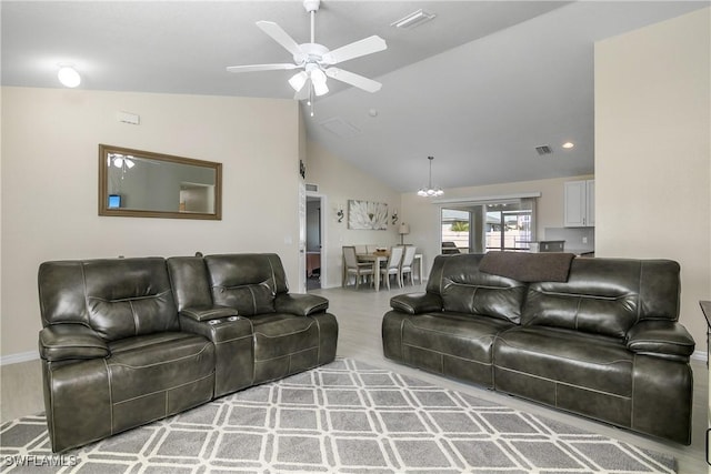 living room featuring lofted ceiling, ceiling fan with notable chandelier, and wood-type flooring