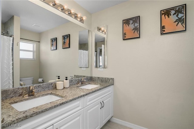 bathroom featuring vanity and toilet