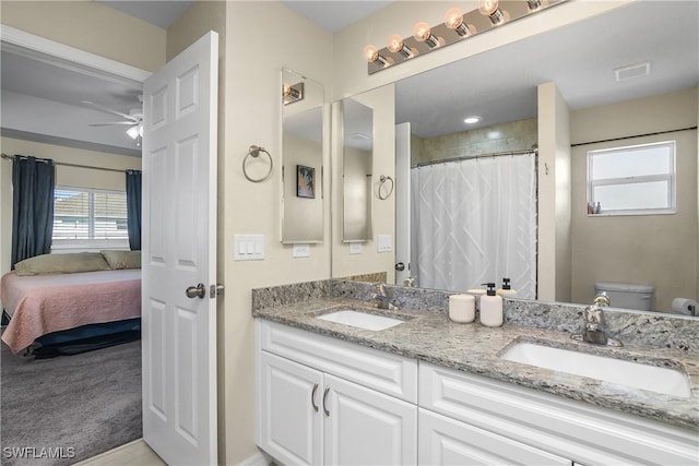 bathroom with vanity, ceiling fan, and toilet