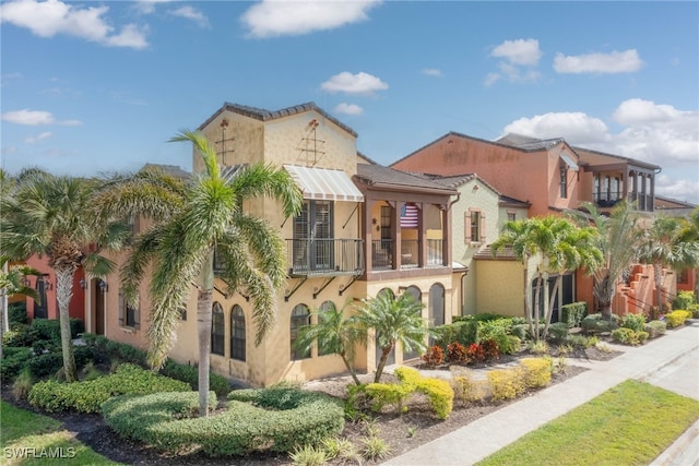 mediterranean / spanish-style home with a balcony