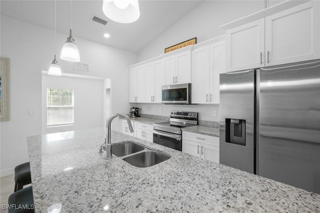 kitchen with hanging light fixtures, appliances with stainless steel finishes, sink, and white cabinets