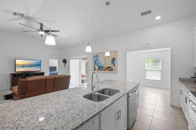 kitchen featuring sink, stainless steel dishwasher, white cabinets, and light stone countertops