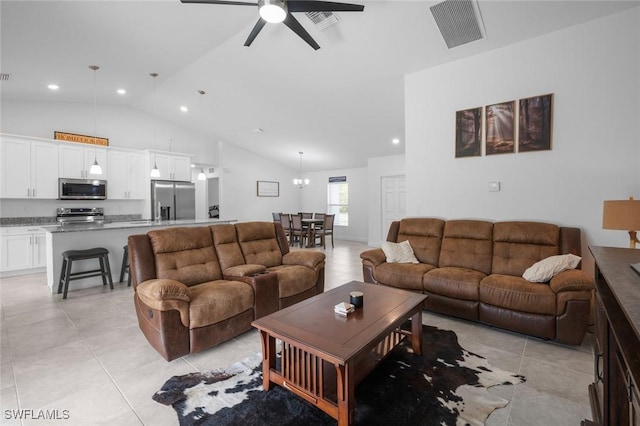 living room featuring light tile patterned floors, vaulted ceiling, and ceiling fan