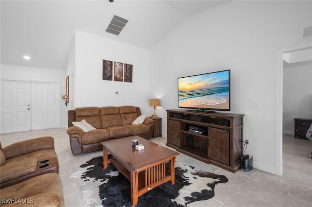 living room featuring high vaulted ceiling and light tile patterned floors