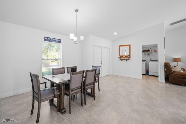 dining area with washing machine and clothes dryer, lofted ceiling, and a notable chandelier