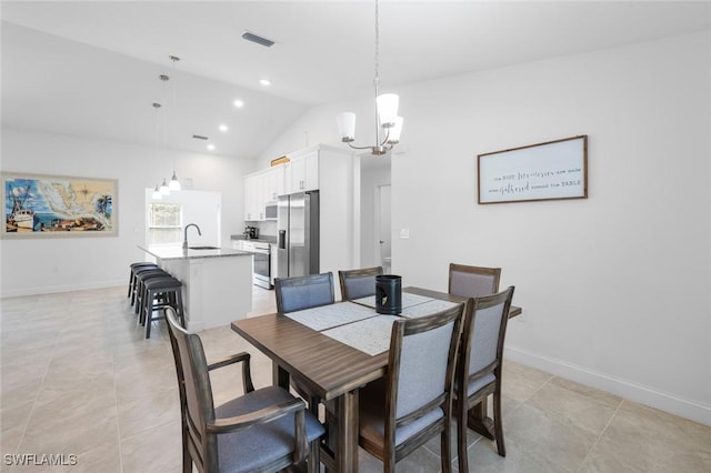 tiled dining space with sink, vaulted ceiling, and a chandelier