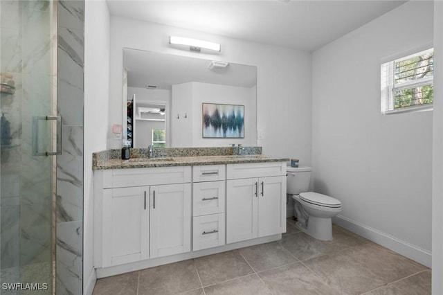 bathroom featuring vanity, toilet, and a shower with door