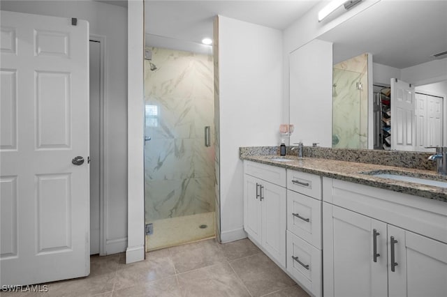 bathroom featuring vanity, a shower with shower door, and tile patterned flooring