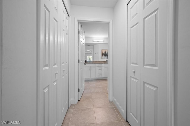 hallway featuring light tile patterned floors