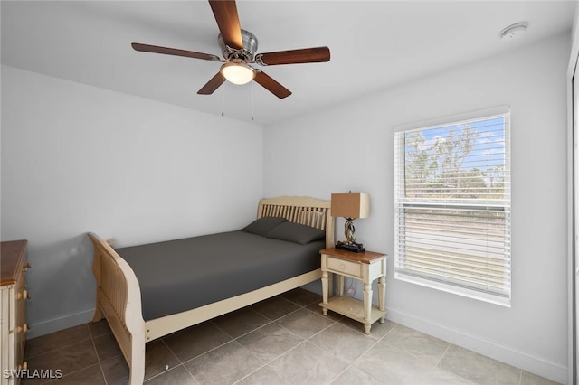 bedroom with ceiling fan and tile patterned flooring