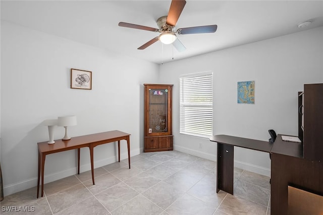 home office with light tile patterned floors and ceiling fan