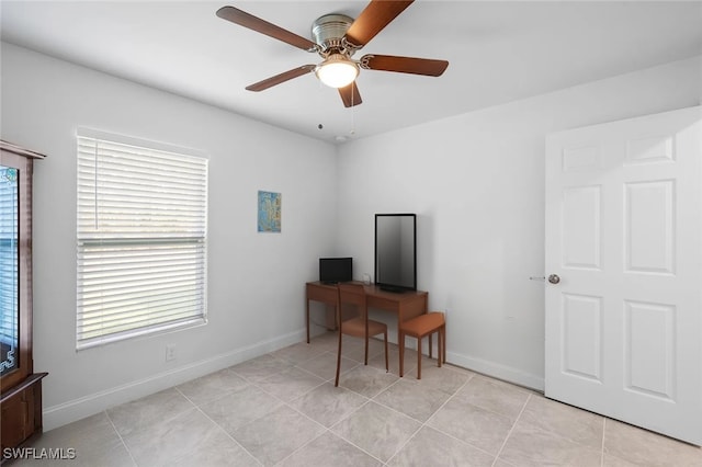 office space featuring light tile patterned flooring and ceiling fan