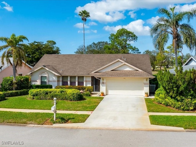 single story home with a garage and a front lawn