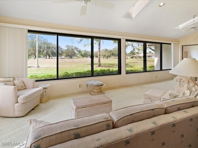 unfurnished sunroom featuring a healthy amount of sunlight, vaulted ceiling with skylight, and ceiling fan