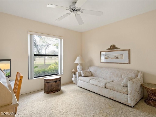 carpeted living room with ceiling fan