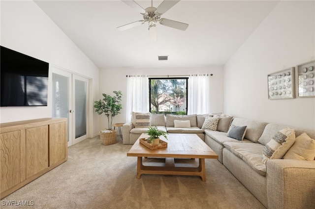 living room featuring ceiling fan, light colored carpet, and vaulted ceiling